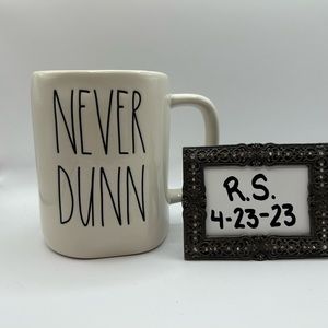 Rae Dunn “Never Dunn” mug.